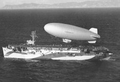 WWII. Blimp over jeep aircraft carrier.jpg