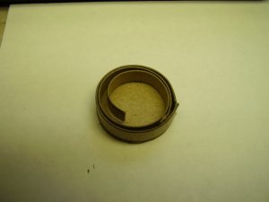 Tread strip timmed, outer surface down, backing strip coil..JPG